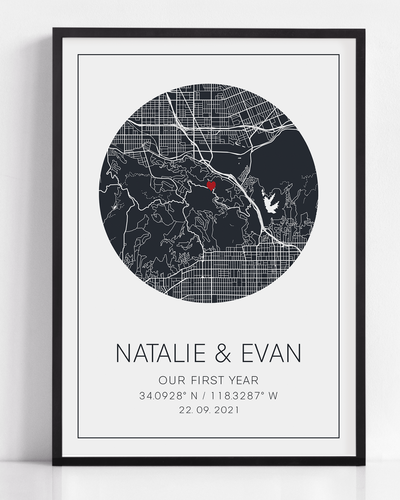 A framed print of a paper anniversary gift print. This custom map print shows the anniversary map gift. The design is unique to your date, location and is purchased as a personalized gift.
