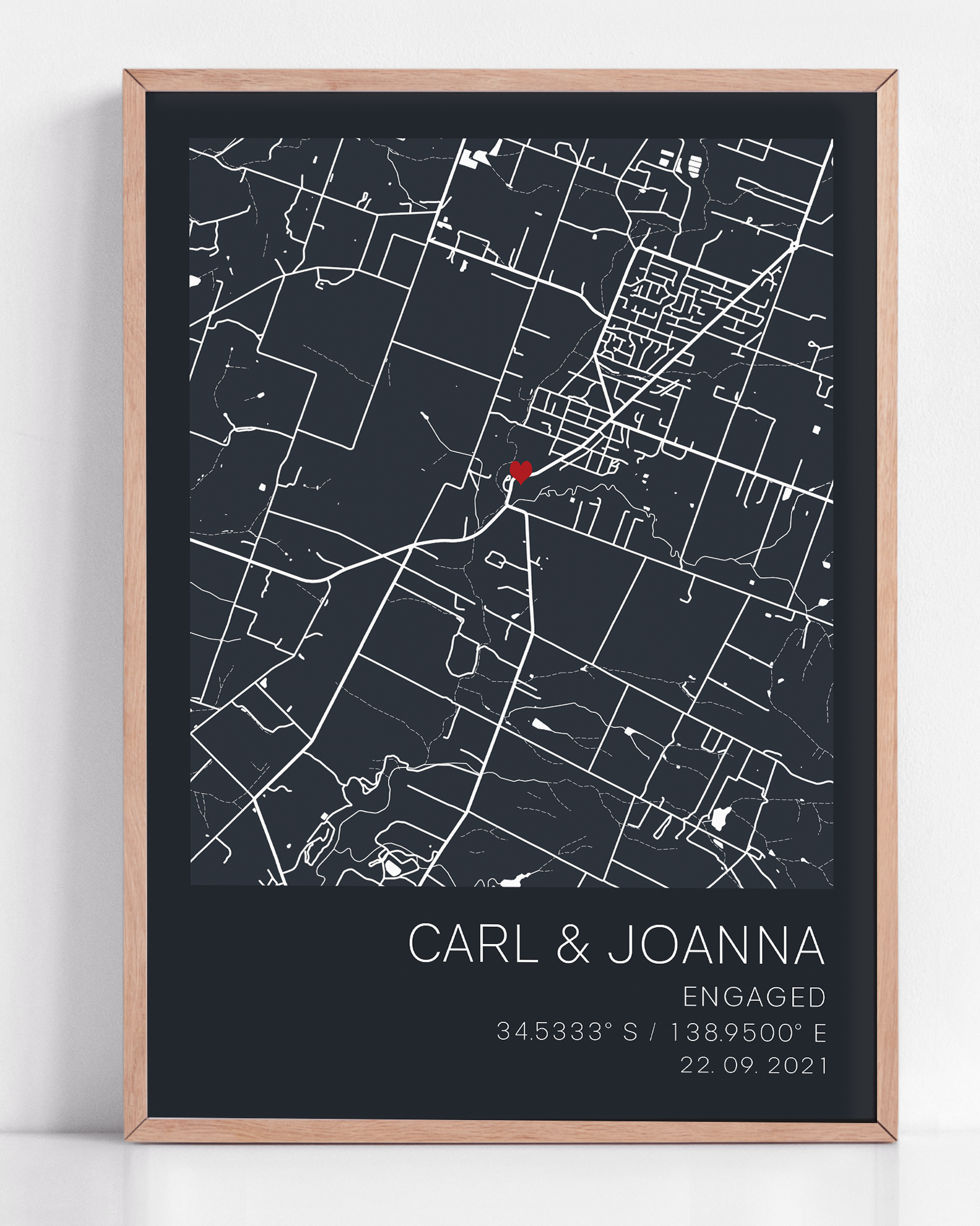 Custom engagement gift: modern city map print with red heart location marker, framed and personalized with names and proposal date in sleek typography