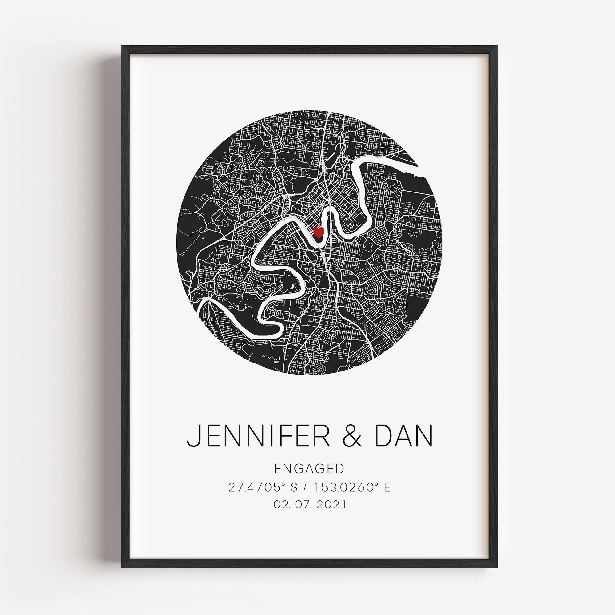 Personalized engagement circle map print featuring a minimalist grey street map within a circular frame, with a red heart marking the proposal location and custom couple names and engagement date in elegant script below.