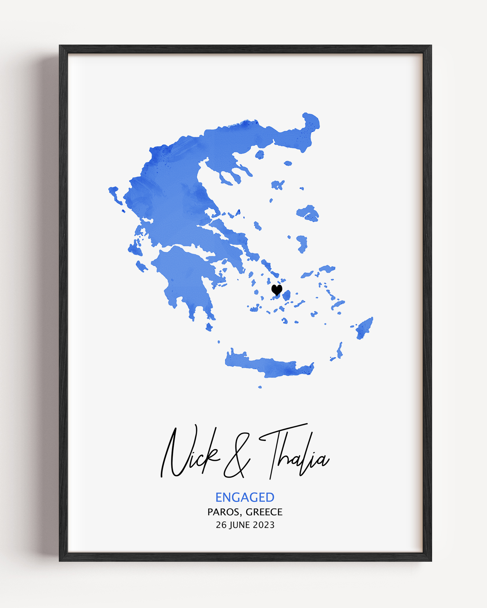 Personalized watercolor engagement map print featuring soft pastel tones, a red heart marking the proposal location, and custom couple names and date in elegant script below the map.