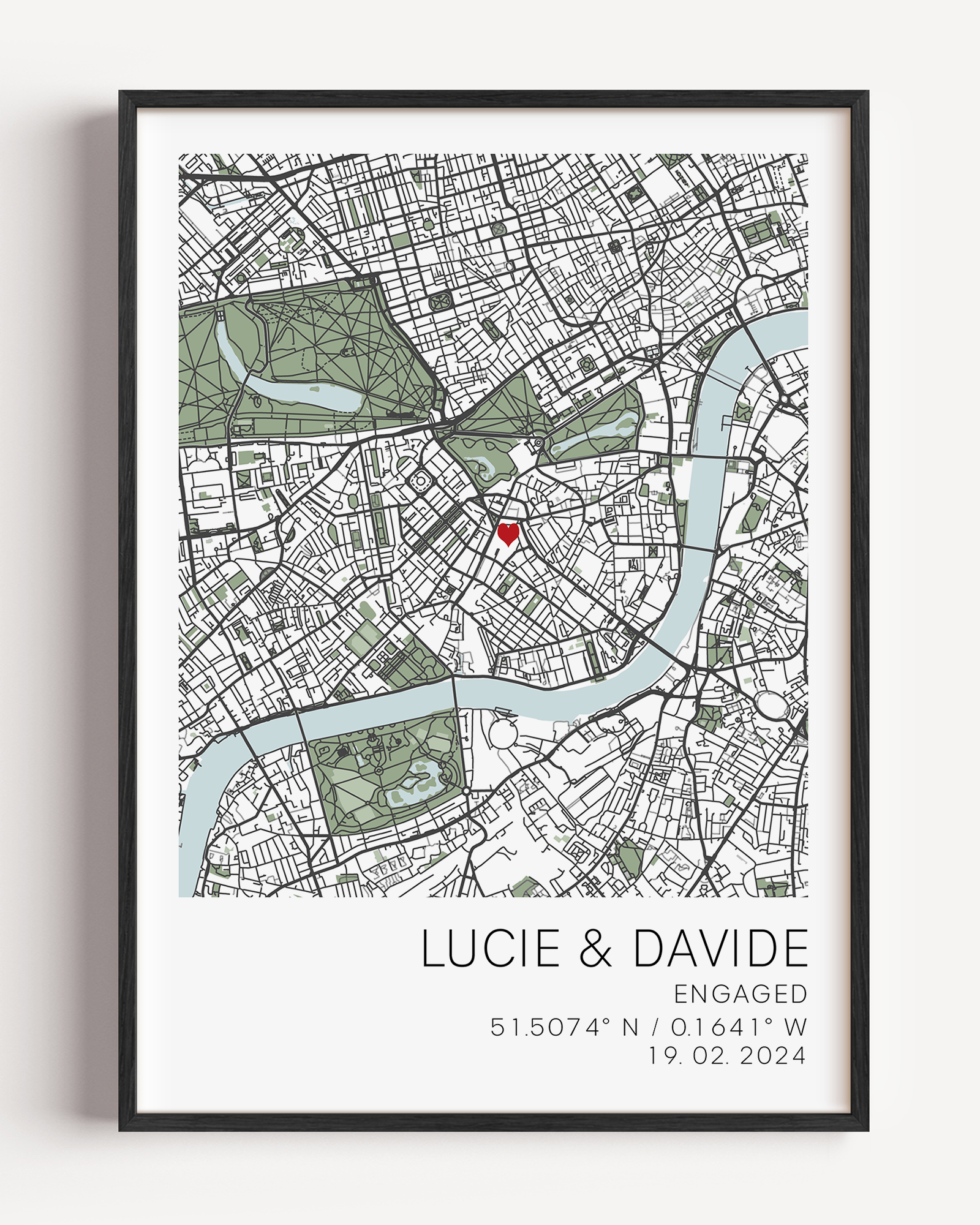 Custom engagement map print showing a colourful map of the proposal location with a small red heart marker, personalized cursive names and date text below on white background