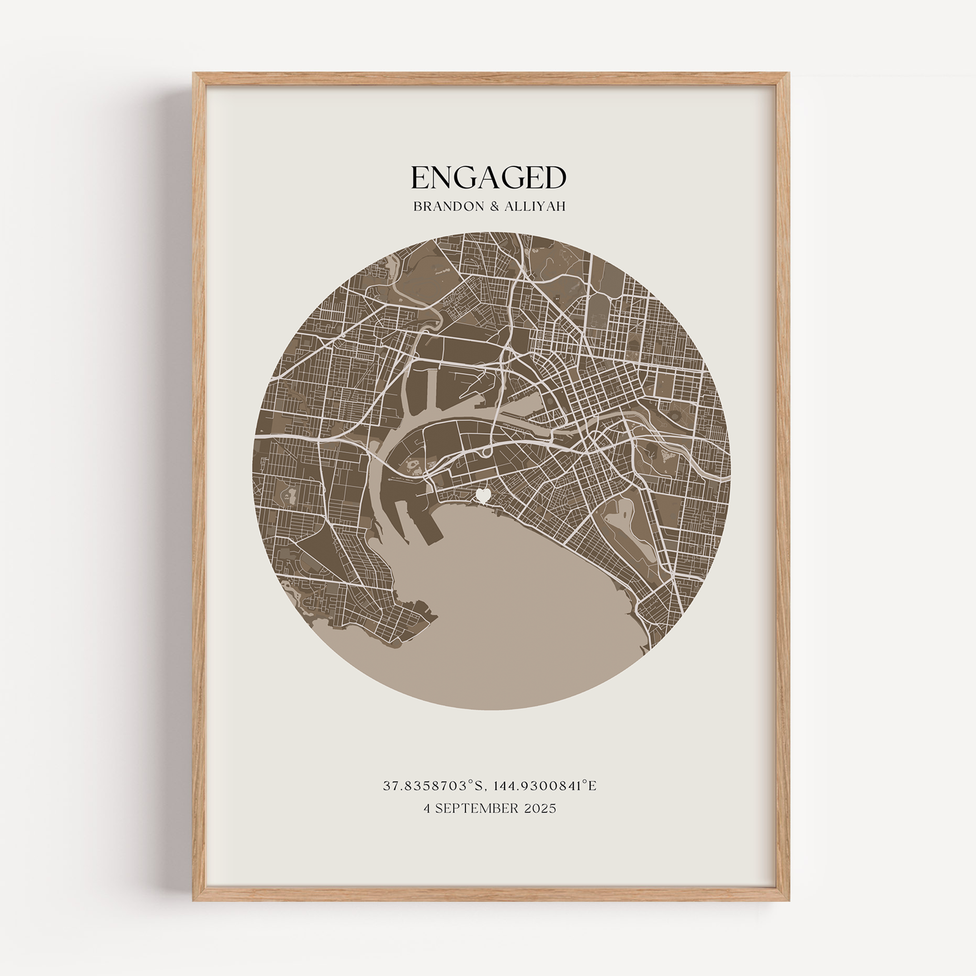 Framed map print with 'Engaged' text and coordinates on a white background, a custom engagement map for a newly engaged couple