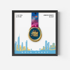 A framed personalized Gold Coast marathon medal print featuring a gold and blue 2KM medal with a pink and blue ribbon, displayed on a white background with a blue and yellow coastal city skyline and the text 'GOLD COAST'. Personalized details for Jennifer Roberts are shown on the print.