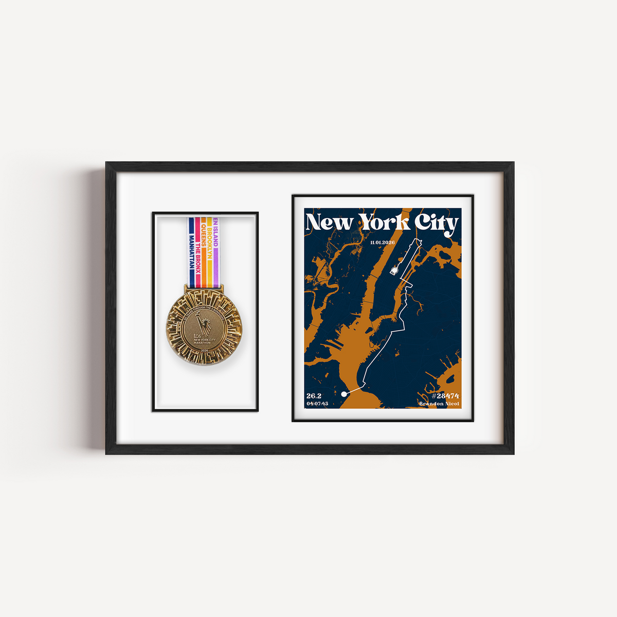 Front view of the Mark Your Moment Urban medal frame displaying a TCS New York City Marathon medal alongside a custom print showing the five-borough race route, runner name, finish time, and bib number.