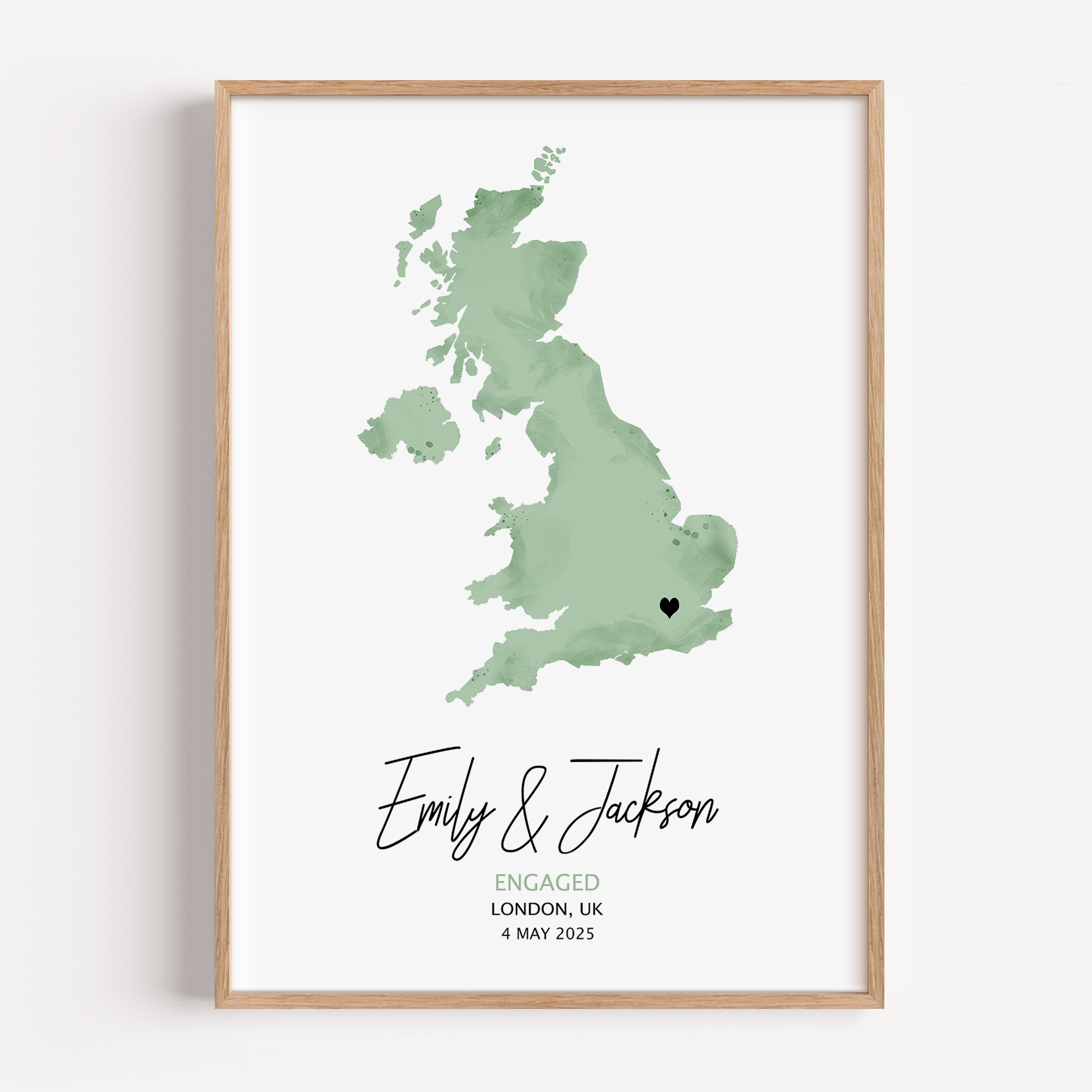 Personalized watercolor green engagement map print featuring soft pastel tones, a red heart marking the proposal location, and custom couple names and date in elegant script below the map.