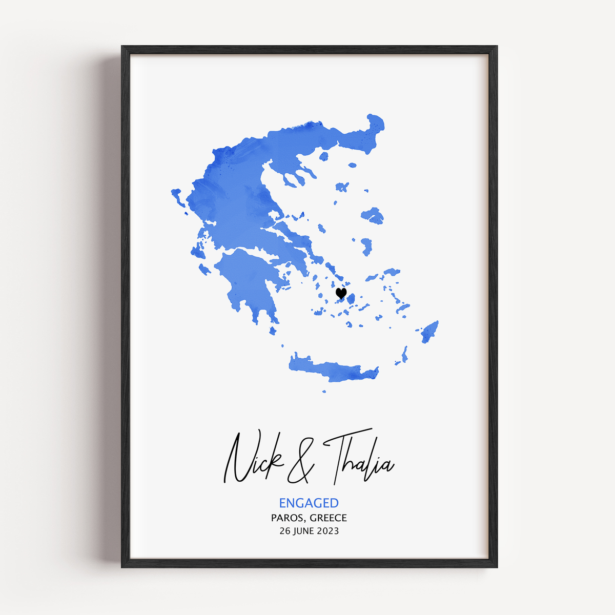 Personalized watercolor engagement map print featuring soft pastel tones, a red heart marking the proposal location, and custom couple names and date in elegant script below the map.