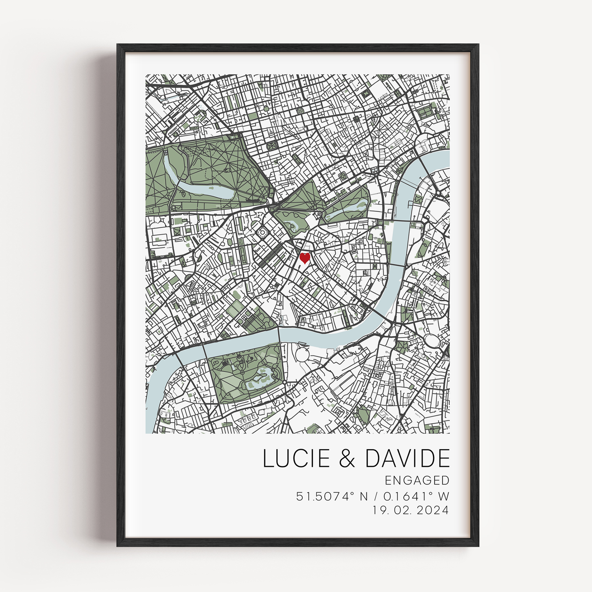 Custom engagement map print showing a colourful map of the proposal location with a small red heart marker, personalized cursive names and date text below on white background