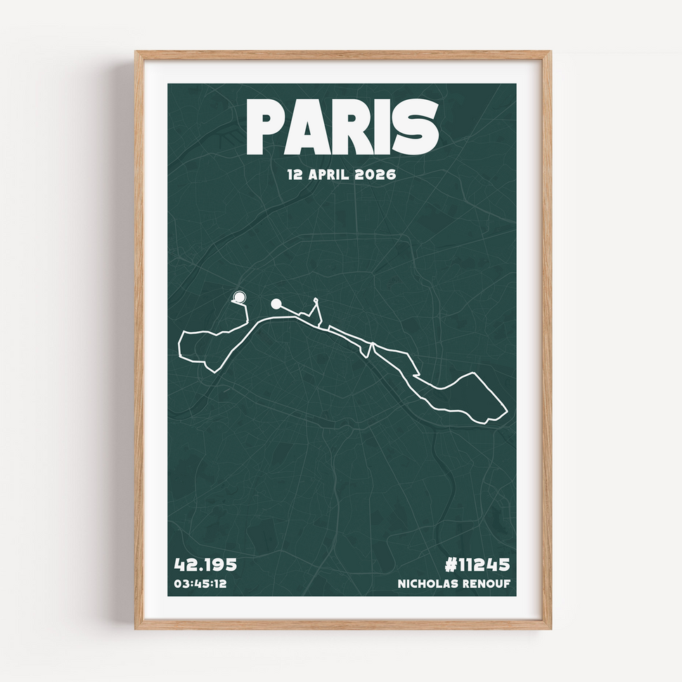 A framed Paris Marathon Urban Edition print in a light wood frame. The design features a deep forest green background with a white marathon route overlay, bold block typography at the top saying PARIS, and personal race stats like finish time and bib number at the bottom.